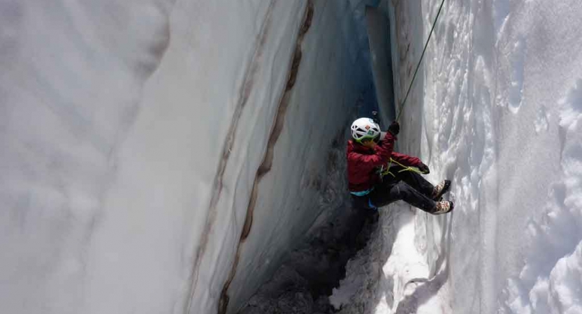 a person rappels into a snowy crevice on a mountaineering expedition in the pacific northwest 